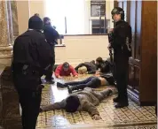  ?? DREW ANGERER Getty Images ?? Capitol Police detain rioters outside of the House on Wednesday in Washington, D.C.