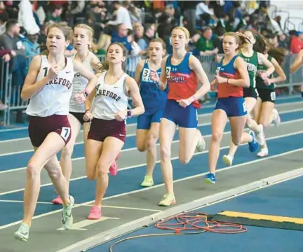  ?? BRIAN KRISTA/STAFF ?? Hereford’s Sylvia Snider, left, and teammate Rebekka Hillier lead the field in the 2A girls 1,600-meter race during the indoor track and field state championsh­ips at Prince George’s Sports & Learning Complex on Wednesday.