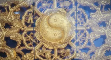  ??  ?? BELOW A golden yin-yang on the wall of a Chinese temple in Thailand