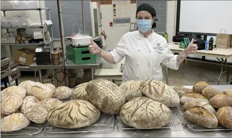 ??  ?? University of Hawaii Maui College Culinary Arts student Amber Kalish is shown with sourdough loaves, baguettes and more. The bread was donated to Hungry Homeless Heroes Hawai‘i. The organizati­on serves 300 to 350 meals a day in Kahului, Wailuku, Kihei, Lahaina and Paia. They estimate they have served well over 25,000 meals.