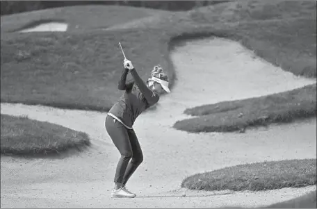  ?? NANNA KOERSTZ MADSEN Denis Poroy Associated Press ?? hits out of the bunker on the first hole en route to taking the third-round lead in Carlsbad.