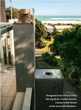  ??  ?? Designed to be viewed from the top deck, a water feature connects the house to the sea in the distance.