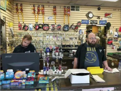  ?? COREY WILLIAMS — THE ASSOCIATED PRESS ?? In this photo, James Murphy, left, and Bryan Knoche work the counter at Fred’s Key Shop in Midtown Detroit. Five years after Detroit filed for the largest municipal bankruptcy in U.S. history, Knoche says the small, family-owned locksmith business is...