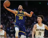  ?? AP PHOTO/GODOFREDO A. VÁSQUEZ ?? Golden State Warriors guard Stephen Curry (30) shoots between New Orleans Pelicans guards Jose Alvarado, left, and Dyson Daniels during the first half of an NBA basketball game Friday, April 12, 2024, in San Francisco.