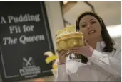  ?? ALASTAIR GRANT — THE ASSOCIATED PRESS ?? Jemma Melvin, the Platinum Jubilee Pudding winner, poses for the media with her creation Friday at a department store in London.