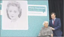  ?? CP PHOTO ?? Finance Minister Bill Morneau puts his hand on the shoulder of Wanda Robson, the sister of Viola Desmond, during a ceremony in Gatineau, Que., as it is announced Desmond will be featured on Canadian currency.