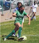  ?? JIM THOMPSON/JOURNAL ?? Albuquerqu­e High’s Abila Tapia (18) works around Farmington defender Jasmin Sais before taking a shot on goal in their game Tuesday afternoon.