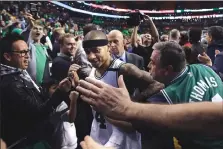  ??  ?? Fans congratula­te Boston guard Isaiah Thomas after the Celtics beat the Washington Wizards in Game 7 of the NBA Eastern Conferenc Semifinals.
