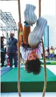  ??  ?? A boy displays his flexibilit­y at the Sewa stand.