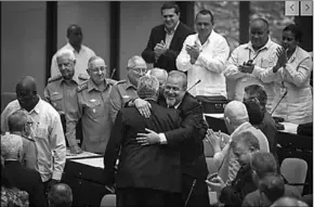  ??  ?? Cuban Prime Minister Manuel Marrero Cruz embraces Cuba’s President Miguel Diaz-Canel during the closing session at the National Assembly of Popular Power in Havana, Cuba, Saturday. DiazCanel named the former Tourism Marrero Cruz as the country’s first Prime Minister since 1976.