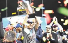  ?? AFP ?? The USA’s Marcus Stroman lifts the trophy after his team beat Puerto Rico to win the 2017 World Baseball Classic on Wednesday.