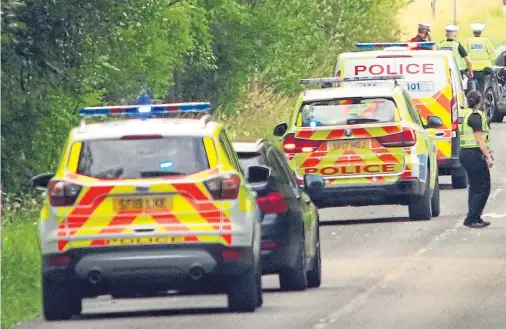  ??  ?? STANDSTILL: Police at the scene of the three-car collision near Oban which saw one man airlifted to hospital and others treated at the scene