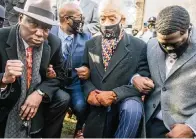  ?? BRANDON BELL Getty Images ?? From left, attorney Ben Crump, Rev. Al Sharpton, and the family of George Floyd kneel for 8 minutes, 46 seconds in Minneapoli­s.