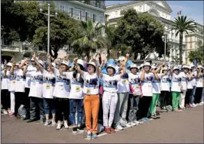  ?? AP/LIONEL CIRONNEAU ?? Employees of the Tiens Group — a Chinese company that sells medical products, including via direct marketing — cheer as they attend a parade organized by Chief Executive Officer Li Jinyuan on the Promenade des Anglais, Nice, in southeaste­rn France...