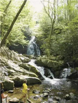  ?? DUNCAN MANSFIELD/AP ?? A boy plays at the bottom of Spruce Flats Falls near Tremont, Tennessee, in the Great Smoky Mountains National Park.