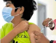  ?? —AFP ?? YOUNGER A minor receives Pfizer-BioNTech COVID-19 vaccine in Paraguay on July 23. The drugmakers are seeking approval for their jab to be given to children from 5 to 11.