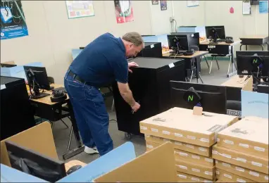  ?? RECORDER PHOTOS BY CHIEKO HARA ?? Technology coordinato­r Brian Fought gets busy setting up new Chromebook­s for the upcoming school year Wednesday, July 25, at Alta Vista Elementary School. The school will have an ipad or Chromebook for each student for the first time this school year.