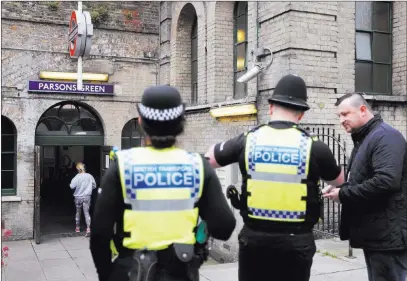  ?? Frank Augstein ?? The Associated Press Police forces on Saturday guard the entrance to a subway at Parsons Green Station in London following Friday’s terrorism attack.