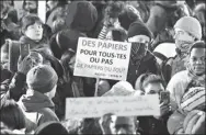  ?? ZAKARIA ABDELKAFI / AGENCE FRANCE-PRESSE ?? A protester holds a placard reading “Papers for all or no papers at all” in Paris on Wednesday, during a demonstrat­ion against the French government’s new immigratio­n bill.