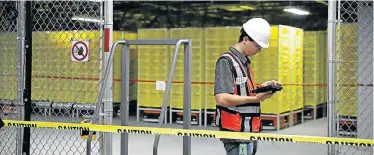  ?? JUSTIN SULLIVAN/GETTY IMAGES Picture: ?? OPERATING MANAGER: A worker tests robotic technology and vision systems at an Amazon fulfillmen­t centre in Sacramento, California