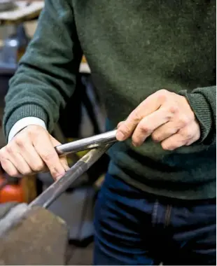  ??  ?? Stephen Wessel burnishes the silver tubular body of the flute to the required thickness and bore hole diameter.