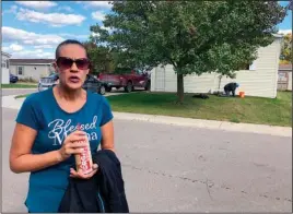  ?? The Associated Press ?? WITNESS: Melissa Merola stands outside the home where Ty Garbin was arrested Thursday in Hartland Township, Mich. Merola said she watched as police, the FBI and what she described as “the military” converged on a mobile home Wednesday, and eventually took two men out in handcuffs. Garbin is one of multiple people who have been charged in federal court with plotting to kidnap Michigan Democratic Gov. Gretchen Whitmer at her vacation home.