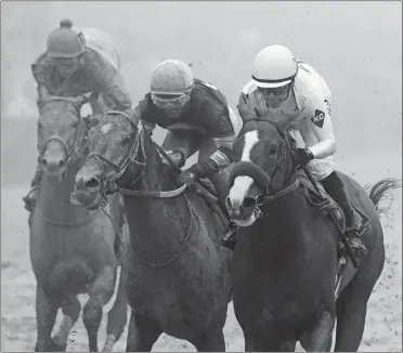  ?? STEVE HELBER/AP PHOTO ?? Justify with Mike Smith atop, right, wins the 143rd Preakness Stakes on Saturday in Baltimore. Tenfold with Ricardo Santana Jr. aboard, middle and Lone Sailor with Irad Ortiz Jr. atop is seen at left.