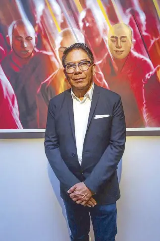  ??  ?? Century Properties Group chairman and CEO Jose E.B. Antonio, one of the six participat­ing photograph­ers of “When Lens Meets Brush,” stands against his collaborat­ion with National Artist Benedicto “BenCab” Cabrera titled “Meditation­s in Red.”