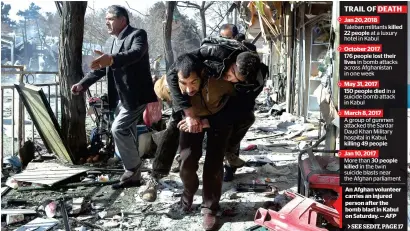  ?? AFP ?? An Afghan volunteer carries an injured person after the bomb blast in Kabul on Saturday. —