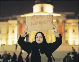  ?? AP PHOTO ?? A woman holds up a sign at a vigil for the victims of Wednesday’s attack at Trafalgar Square in London.