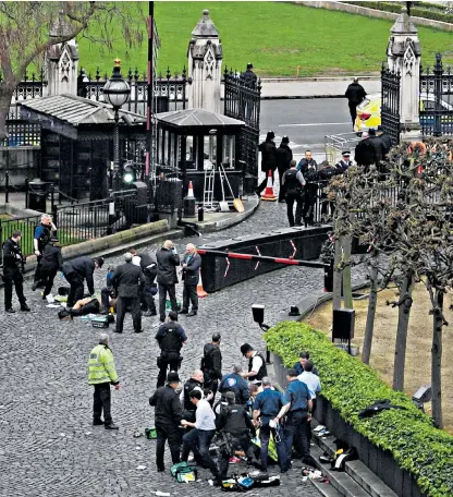  ??  ?? The scene outside the Palace of Westminste­r in March last year as emergency services attend Pc Keith Palmer after he had been stabbed by Khalid Masood