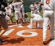  ?? STEPHEN SPILLMAN / FOR AUSTIN AMERICAN-STATESMAN ?? Texas players celebrate in center field after clinching their series with a 5-2 win over Tennessee Tech in Austin on Monday.