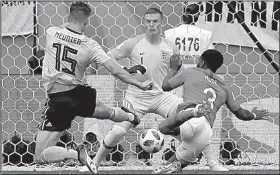  ?? AP/PETR DAVID JOSEK ?? Thomas Meunier (left) scores Belgium’s opening goal against goalkeeper Jordan Pickford as England’s Danny Rose tries to defend during Saturday’s World Cup third-place match at St. Petersburg Stadium in St. Petersburg, Russia. Belgium won 2-0.