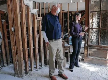  ?? Elizabeth Conley / Houston Chronicle ?? Ken Akre, a recent heart transplant recipient, looks at the damage of his daughter Megan Hebert’s home in Houston recently.