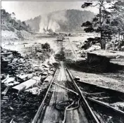  ?? OBJECT ID #1973-182-1218, ALICE EARL WILDER COLLECTION, KELLEY HOUSE MUSEUM ?? A photograph of a stereograp­h showing the Incline on the tramway from the Big River Mill, where the lumber was cut and planed, to the Shipping Point, where it was stored until loaded onto ships that anchored in Mendocino Bay. The Mill, seen in the background with smoke around it from the wood-fired boilers for the steam engines, was located on the east end of Big River Beach.