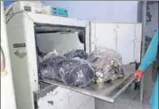  ?? SANJEEV KUMAR/HT ?? The body parts of Indian Air Force employee Vipin Shukla (below) wrapped in plastic bags in the mortuary of Bathinda civil hospital, and (right) his wife with a relative on Wednesday.