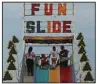  ?? (Democrat-Gazette file photo/ Colin Murphey) ?? Young people prepare to ride down a slide during the Pulaski County Fair in North Little Rock’s Riverfront Park in May 2022.