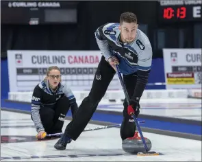  ?? The Canadian Press ?? Brett Gallant sweeps as Jocelyn Peterman releases a rock against Tyrel Griffith and Nancy Faye Martin in the gold medal game at the Canadian mixed doubles curling championsh­ips in Fredericto­n, N.B. on March 24, 2019.