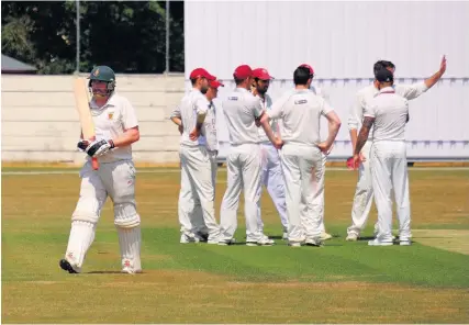  ??  ?? Weston-super-Mare players celebrate the capture of a Keynsham wicket Pictures: Jon Kent