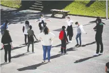  ?? STEPHANE MAHE/REUTERS ?? Students demonstrat­e social distancing in the yard at College Rosa Parks school at its reopening in Nantes, France.