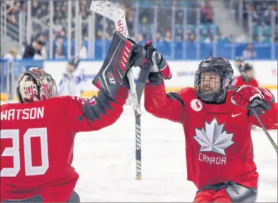  ?? THE CANADIAN PRESS/AP-NG HAN GUAN ?? Canada’s Billy Bridges, centre, celebrates a goal with goalkeeper Corbin Watson during a semifinal match against South Korea in the 2018 Winter Paralympic­s at the Gangneung Hockey Center in Gangneung, South Korea, on Thursday.