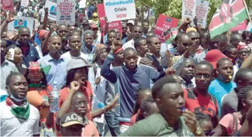  ?? — AFP ?? Striking doctors hold placards and chant slogans outside the Court of Appeal in Nairobi as they pushed for the release of jailed officials of the national doctors’ union as they demanded fulfilment of a 2013 agreement between their union and the...