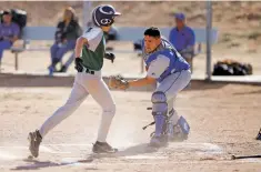  ??  ?? Peñasco’s Danny Esquibel, right, tries to tag Desert Academy’s Mason Moore as he scores a run during the bottom of the first inning.