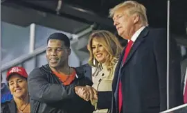  ?? Michael Zarrilli Getty Images ?? REPUBLICAN Herschel Walker, left, a promoter of conspiracy theories, was endorsed by former President Trump in his unsuccessf­ul Senate bid in Georgia.