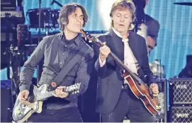  ??  ?? Paul McCartney, right, performs alongside guitarist Rusty Anderson during his performanc­e on day 2 of the 2016 Desert Trip music festival.