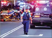  ?? PHOTO: AFP ?? A police officer reacts outside the Westfield Bondi Junction shopping mall after a stabbing incident in Sydney yesterday.