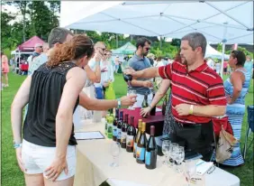  ?? FILE PHOTO ?? Event-goers sample Corinth-based Ledge Rock Hill Winery and Vineyards wine products at the 2016Adiron­dack Wine & Food Festival.