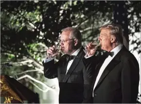  ?? — Bloomberg ?? Meeting of minds: Trump and Morrison drinking during a toast at a state dinner in the Rose Garden of the White House.