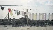  ??  ?? Washed clothing hangs on a line on Makaru Island, which is half the size it was five years ago.