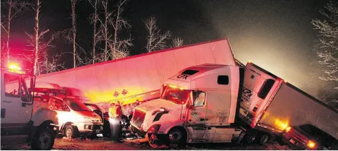  ?? SHANE MACKICHAN / THE CANADIAN PRESS ?? First responders and highways crews, shown late Sunday, worked through the night to help 165 victims involved in a multi-vehicle pileup on an icy stretch of the Coquihalla Highway.